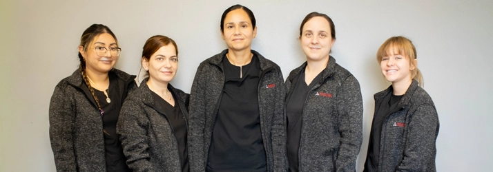 5 team members smiling.